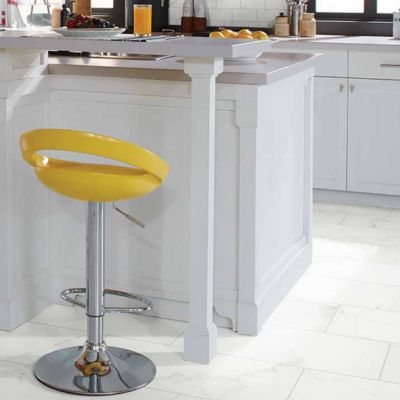 tile flooring in a kitchen with island and yellow stool